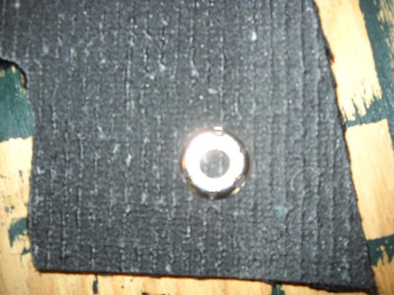 Spriked ring fastners 03.JPG - The snap portion goes through the tines, and the tines are bent over the snap. The black ring is invisible on the opposite side.